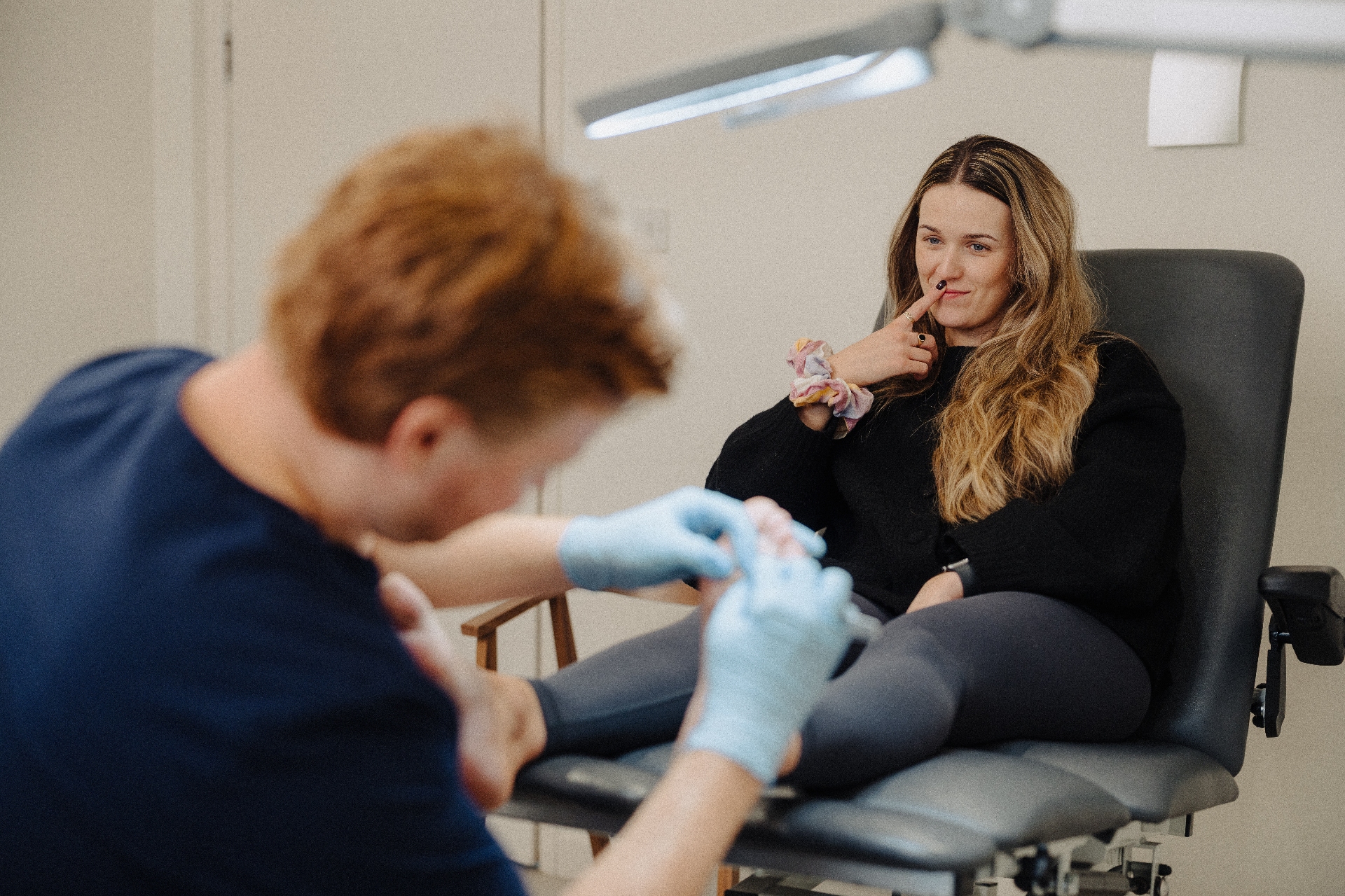 A relaxed patient smiling during her treatment at The Verruca Clinic NI